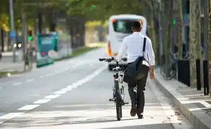 businessman walking with bike street after work